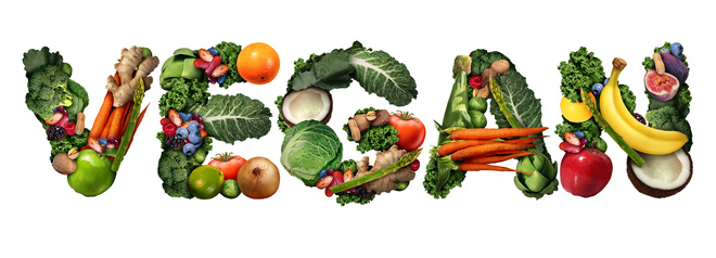 Vegan+concept+and+veganism+lifestyle+icon+as+a+group+of+fruit+vegetables+nuts+and+beans+shaped+as+text+isolated+on+a+white+background+as+a+healthy+diet+symbol+for+eating+green+biological+natural+food.